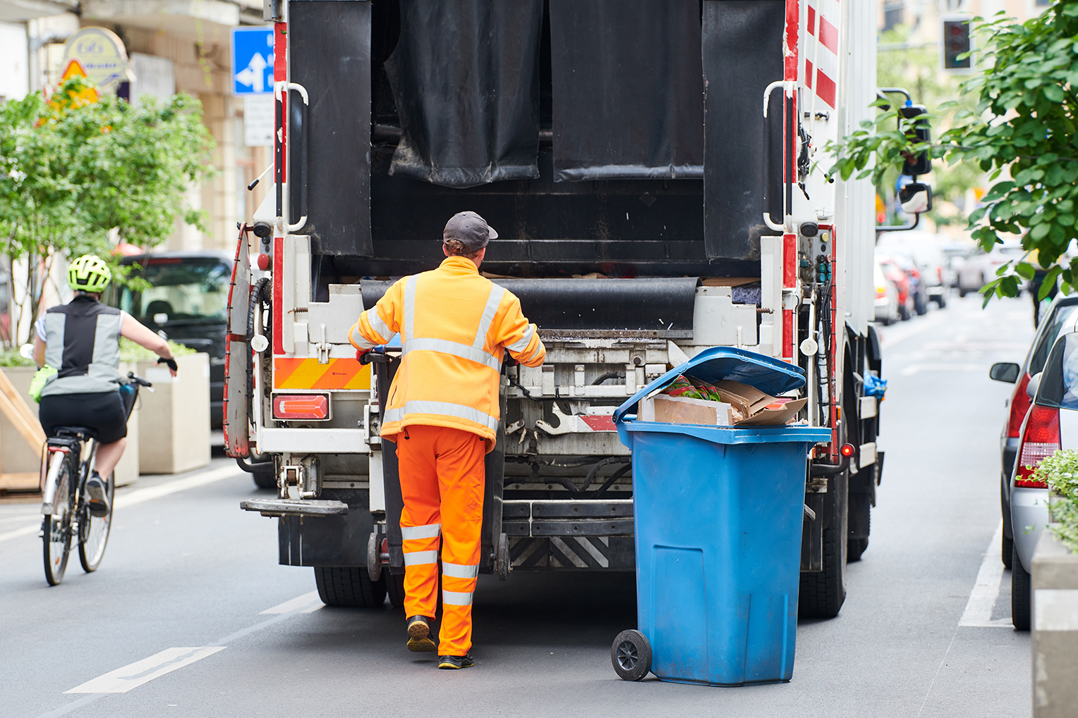 Waste collection crew loading bins